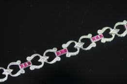 STUNNING 18CT WHITE GOLD SQUARE RUBY AND PAVE SET DIAMOND HORSESHOE BRACELET, rubies estimated 2.6mm