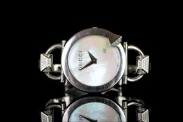 LADIES GUCCI CHIODO , MODEL 122.5,round.mother of pearl with silver hands, date aperture at 4 o