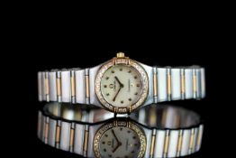 LADIES TWO TONE OMEGA CONSTELLATION WITH DIAMOND BEZEL ,round, white dial with gold hands, gold