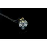 Silver and gold Diamond set skull pendant, approximate total diamond weight 2.46ct, approximate