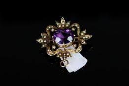 18K AMETHYST AND SEED PEARL BROOCH,centre stone estimated at 13x9mm,total weight 6.78 gms