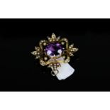 18K AMETHYST AND SEED PEARL BROOCH,centre stone estimated at 13x9mm,total weight 6.78 gms