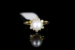 9CT SINGLE CULTURED PEARL AND DIAMOND CLUSTER,centre stone 7mm, total weight 3.6gms, ring size N.
