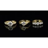 Three cubic zirconia rings, one set in 9ct yellow gold and two set in 14ct yellow gold, total