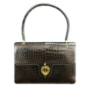 This Hermes handbag from the 1960s is the embodiment of classic style, this brown crocodile bag