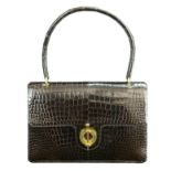 This Hermes handbag from the 1960s is the embodiment of classic style, this brown crocodile bag