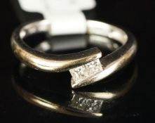 Two stone diamond crossover ring, mounted in white metal stamped 18k, two princess cut diamonds