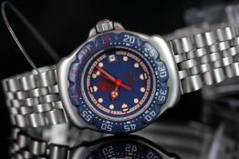 LADIES TAG HEUER F1 WITH BLUE BEZEL, round, blue dial with red hands, illuminated round markers,25mm