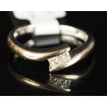 Two stone diamond crossover ring, mounted in white metal stamped 18k, two princess cut diamonds