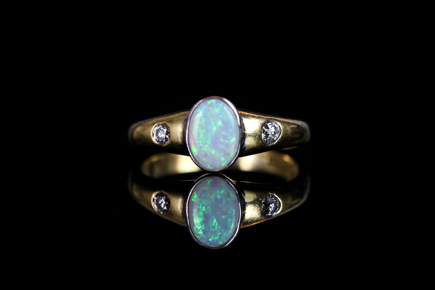 18CT OPAL AND DIAMOND RING, centre stone estimated 8x5mm, total weight 3.9 gms, size M.