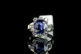 Natural intense blue sapphire and diamond ring, central 3.34ct oval cut blue sapphire accompanied by