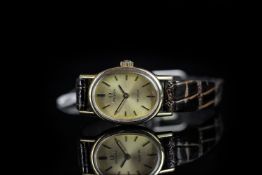 LADIES OMEGA DE VILLE WRISTWATCH, oval champagne dial with gold and black hour markers and hands,