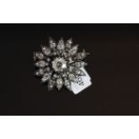 18CT DIAMOND SET STAR BURST BROOCH, centre stone estimated as 1.20ct, mounted with old and rose