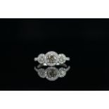 14ct White Gold Diamond trilogy halo ring featuring centre, one round brilliant cut Diamond (0.