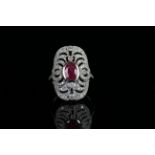 18ct White Gold Ruby and Diamond ring featuring centre, oval cut, pinkish red Ruby (0.91ct), bezel