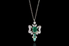 18CT EMERALD AND DIAMOND PENDANT, centre emerald estimated 6.7x5mm, 2 smaller stones estimated