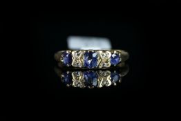 Sapphire and diamond half hoop ring, three sapphires spaced with four rose cut diamonds in yellow