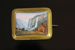 15CT SWISS PORTRAIT BROOCH DEPICTING A WATERFALL AND COTTAGE, total weight 15.40 gms.