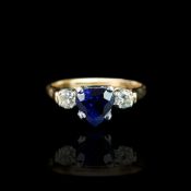 Heart shaped sapphire and diamond three stone ring, mounted in yellow and white metal stamped '