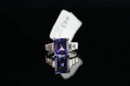 18CT TANZANITE AND BAGUETTE DIAMOND SET SHOULDERS RING, centre stone estimated at 8.8x 7.4 mm, total