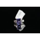 18CT TANZANITE AND BAGUETTE DIAMOND SET SHOULDERS RING, centre stone estimated at 8.8x 7.4 mm, total