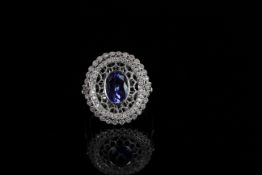18ct White Gold Tanzanite and Diamond ring featuring centre, oval cut Tanzanite (1.42ct), with 17