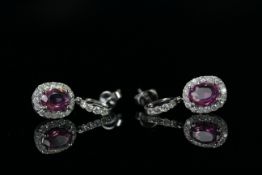 14ct White Gold Sapphire and Diamond drop earrings featuring, 2 oval cut, pink Sapphires (2.23ct