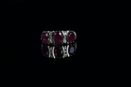 14ct Yellow Gold Ruby and Diamond ring featuring centre, 3 oval cut, reddish pink Rubies, (3.11ct
