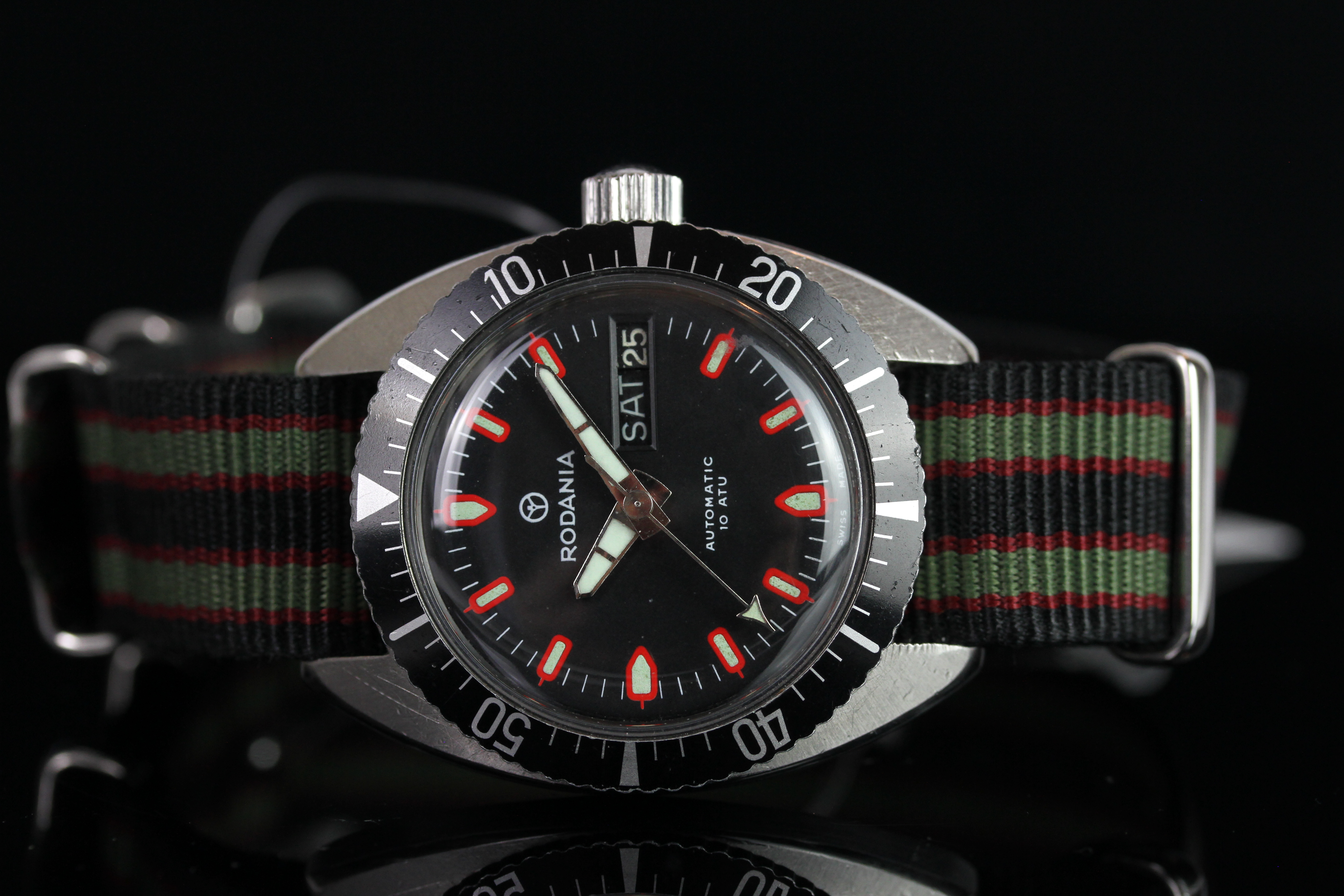 VINTAGE RODANIA AUTOMATIC DIVE WATCH, circular black dial with red and lime hour markers, day and