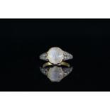 18CT MOONSTONE RING, centre stone 5mm, stone set shoulders, total weight 4.5gms, size N.