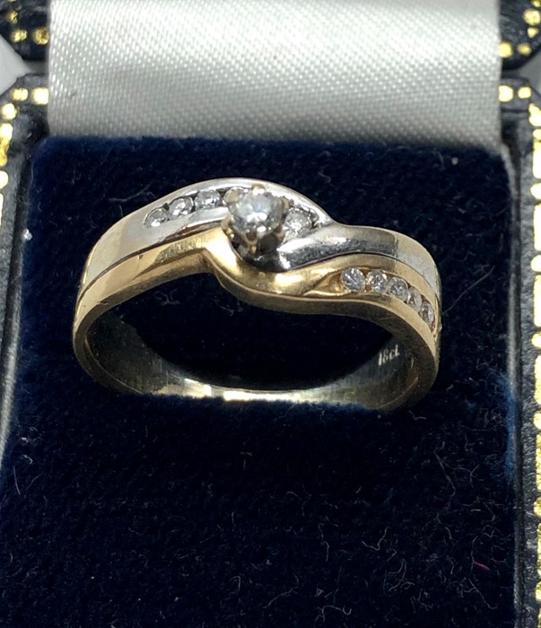 18ct white and yellow gold diamond ring set with central diamond with diamonds either side hallmarke