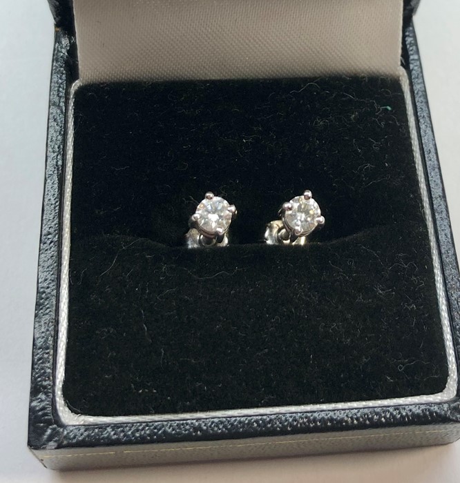 Pair of diamond earrings each set with single diamond that measures approx 4mm dia set in hallmarked