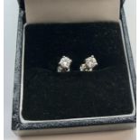 Pair of diamond earrings each set with single diamond that measures approx 4mm dia set in hallmarked