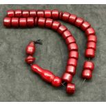 Barrel shaped cherry amber bakelite Islamic prayer beads ,.beads when looked at under torch have gr
