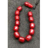 Very large barrel shaped cherry amber bakelite Islamic prayer beads ,.beads when looked at under to