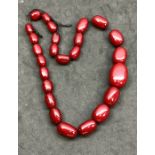 Graduated cherry Amber bakelite beads ,.beads when looked at under torch have great internal stre