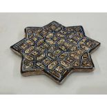 Antique star shaped persian tile measures approx 21cm dia