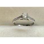 white gold single stone diamond ring with diamond shoulders set with central diamond