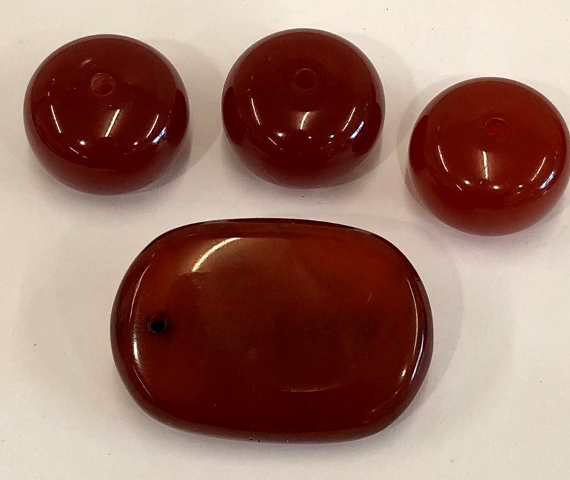 4 large cherry amber bakelite type beads the large bead has good internal streaking