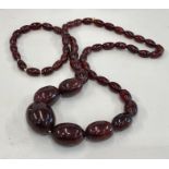 Long string of graduated cherry amber / bakelite beads good internal streaking largest bead measures