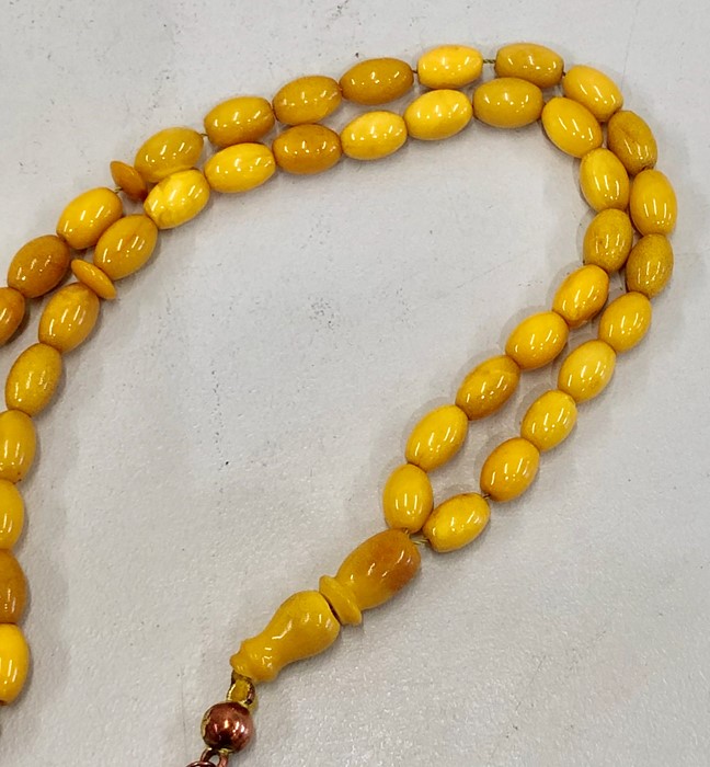 Islamic amber worry beads 45 small beds and 1 big bead the large bead broken in half total weight 20 - Image 2 of 4