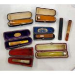 Selection of silver and gold mounted cheroot holders some boxed 2 with amber bodies and hallmarked 9