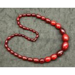 Long string of graduated cherry amber / bakelite beads good internal streaking