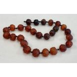 Antique Chinese carved amber bead necklace measures approx 38cm long each bead measures approx 10mm