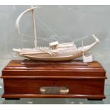 Chinese interest Burmese teak box mounted with an ivory Phinisi junk bearing a silver presentation