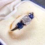 Diamond and sapphire ring set with cental diamond that measures approx 5.5mm dia with two sapphires