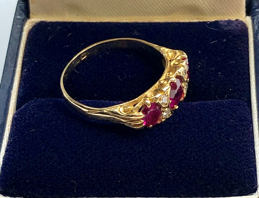 18ct gold diamond and ruby ring set with 3 rubies largest measures approx 5.5mm by 5mm with 4 small - Image 4 of 5