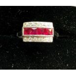 18ct white gold diamond and ruby ring hallmarked 18ct wit a row of rubies with a row of diamonds eac