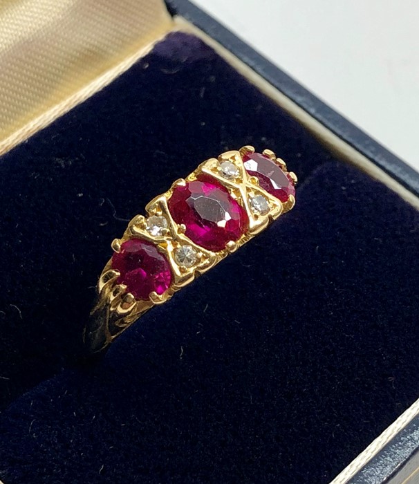 18ct gold diamond and ruby ring set with 3 rubies largest measures approx 5.5mm by 5mm with 4 small - Image 2 of 5