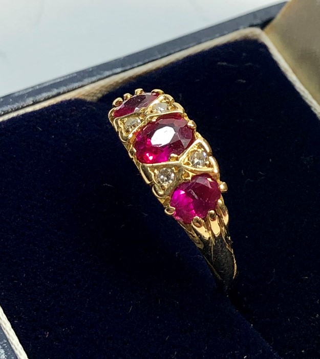 18ct gold diamond and ruby ring set with 3 rubies largest measures approx 5.5mm by 5mm with 4 small - Image 3 of 5